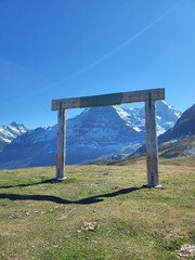 Fototapeta premium A plank gate made on top of mountain in Männlichen with a clear blue sky with portrait size