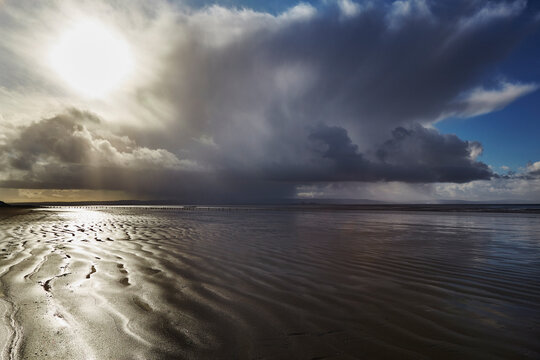 Stormy sunlight on the beach at Berrow, near Burnham-on-Sea, Somerset, Great Britain; Berrow, Somerset, England