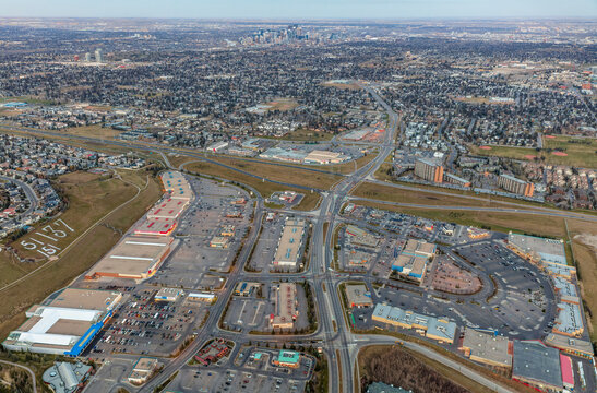 Evening aerial view of the Signal Hill and Westhills shopping centres with the city of Calgary in the background; Calgary, Alberta, Canada