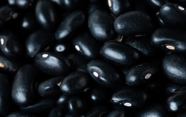 Macro Close up Texture of black bean, round grain beans. Beautiful complete seed pea bean, food object design. Selective focus freeze shot black background isolated