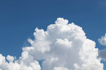 White cumulus clouds in the blue sky, illuminated by the bright spring sun.
