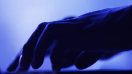 Hands typing on a keyboard with a blue hue - Powered by Adobe