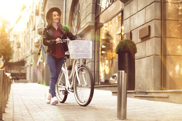 Obraz na płótnie Canvas Beautiful happy woman with bicycle in city on sunny day