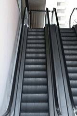 View on empty parallel escalators with grey balustrades