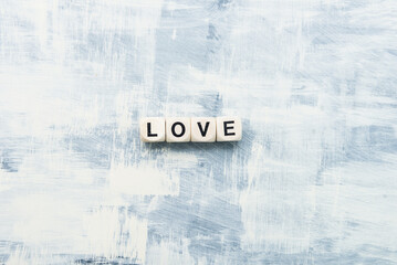 The inscription from wooden cubes LOVE on a light background. Gift concept for Valentine's day.