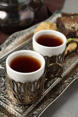 Tea served in vintage tea set on grey table, closeup