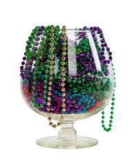 Isolated brandy glass filled with colorful mardi gras beads - obrazy, fototapety, plakaty