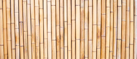 Fotobehang Yellow bamboo texture. Dried bamboo wall or fence background © Bowonpat