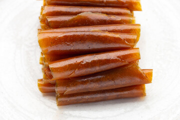 Dried mango paste sheets on white background.