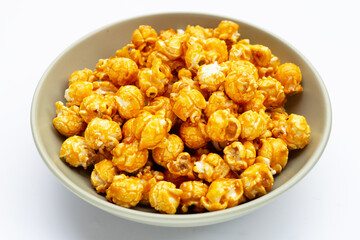 Honey caramel popcorn on white background.