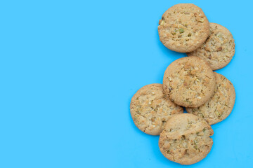 Pistachio and almond cookies on blue background.