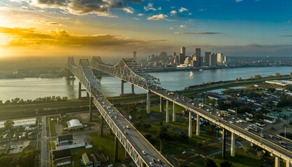 Aerial sunset view of the Crescent City Connector bridge over the Mississippi river in New Orleans Louisiana with colorful sunset sky