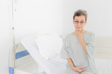 Asian patient rest on bed and use hand touch on her neck, she feeling tonsillitis pain, she admit in hospital