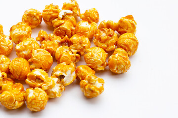 Honey caramel popcorn on white background.