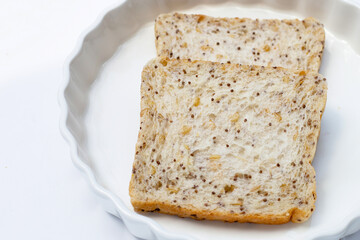 Whole grain bread slices on white background.