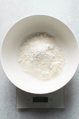 All purpose flour in a white bowl, baking flour in a large bowl	