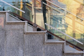 Beautiful grey stairs with tempered glass outdoors