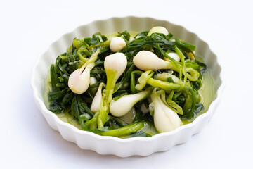 Pickled spring onion in white bowl