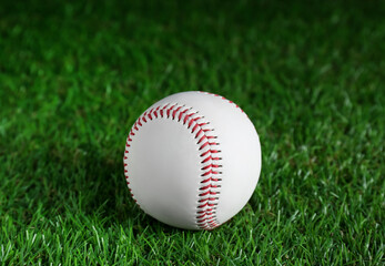 Baseball ball on green grass, closeup. Sports game