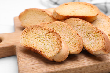 Tasty hard chuck crackers on white wooden table, closeup