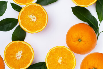 Orange fruit with green leaves on white background.