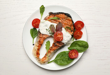 Tasty salmon steak served on white wooden table, top view