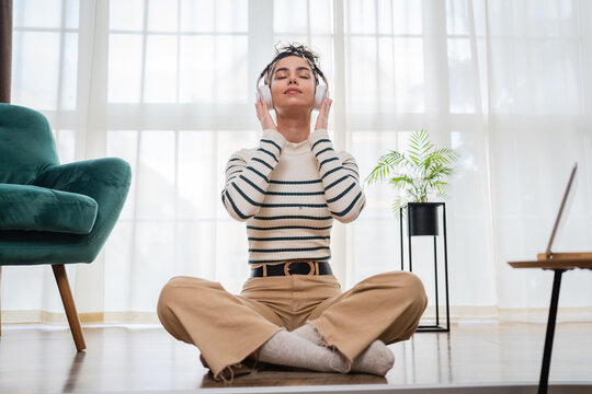 One Woman Doing Guided Meditation Yoga Self Care Practice At Home