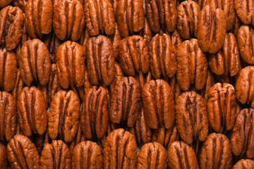 Tasty fresh ripe pecan nuts as background, top view