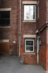 Rear view of generic old brick apartment buildings, urban scene, vertical aspect