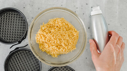 Cracker crust for cheesecake recipe. Mixing crushed crackers with melted butter. Homemade mini cheesecakes preparation process, close-up ingredients, flat lay