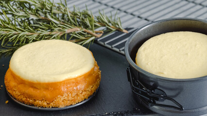 Mini cheesecakes, and ingredients for the dessert topping close-up on kitchen table