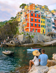 A couple visit Riomaggiore Cinque Terre Liguria, Italy. seascape of the Mediterranean sea. Traveling concept background.