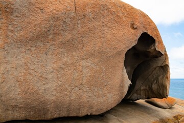 Remarkable Rocks in Flinders Chase National Park on Kangaroo Island, South Australia. Rocks covered by golden orange lichen. Black mica, bluish quartz and pinkish feldspar comprise most of the granite