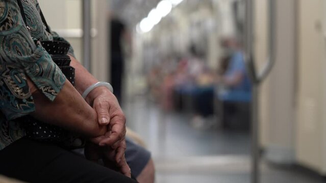 Crop View Of An Elderly Woman Riding A Train Transport In Bangkok, Thailand. Selective Focus Shot