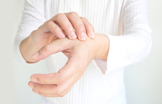 Man's hand. He massaged his hand and had finger pain. Locked fingers from work and office syndrome on a white background medical concept