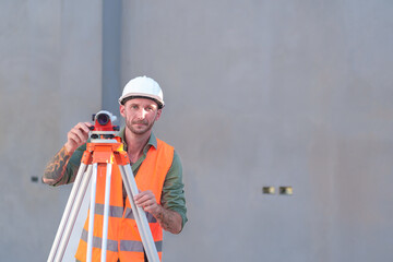 Survey engineers at construction sites use theodolite to mark coordinating concrete piles.