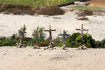 group of wooden crosses with desert landscape in the background