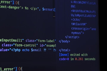 The software developer is doing php coding. Abstract code background. Selective focus code on computer screen