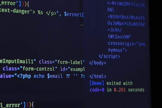 The software developer is doing php coding. Abstract code background. Selective focus code on computer screen