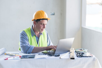 Architect concept, Architects working with blueprints in the office Business accessories (laptop, smartphone, pens, magnifier), accessories for drawing (plans, rulers) and learning on the table