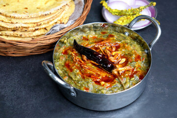Sarson ka saag and Makke di roti. mustard leaves curry. It's a popular Punjabi winter dish made using corn meal and mustard leaves. served with onions and green chili. with copy space.