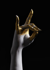 A woman's right arm, painted in gold and white  on a dark background. Hand sign meaning fox in Japan. 3D illustration.