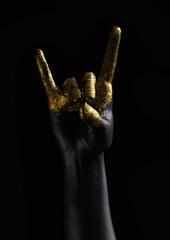 A woman's right arm, painted in gold and black  on a dark background. Hand sign meaning fox in Japan. Front view. 3D illustration.