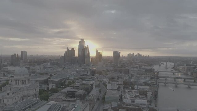 Beautiful golden sunrise establishing shot of the london city skyline. Flying into the Gherkin buildings with St Pauls Cathedral on the left. Shot with the Mavic 3 Cine Prores 422HQ 4k