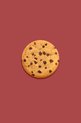 chocolate chip cookie on red background