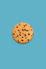 cookie with chocolate chips on light blue background