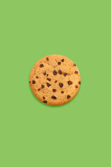 chocolate chip cookie on green background