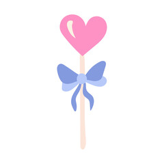 Lollipop in the shape of a heart on a stick with a bow