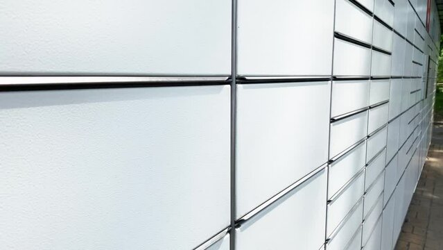Pickup station - logistical point, automat terminal for depositing items, is a modern parcel locker with many postal boxes. Self-service Contactless Automated Postal Box. Modern Shipping and Delivery
