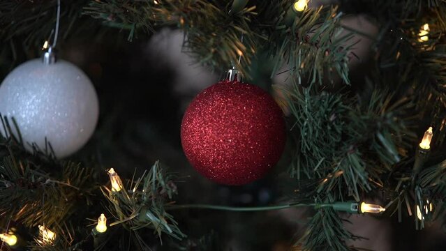 White and red ornament on Christmas tree